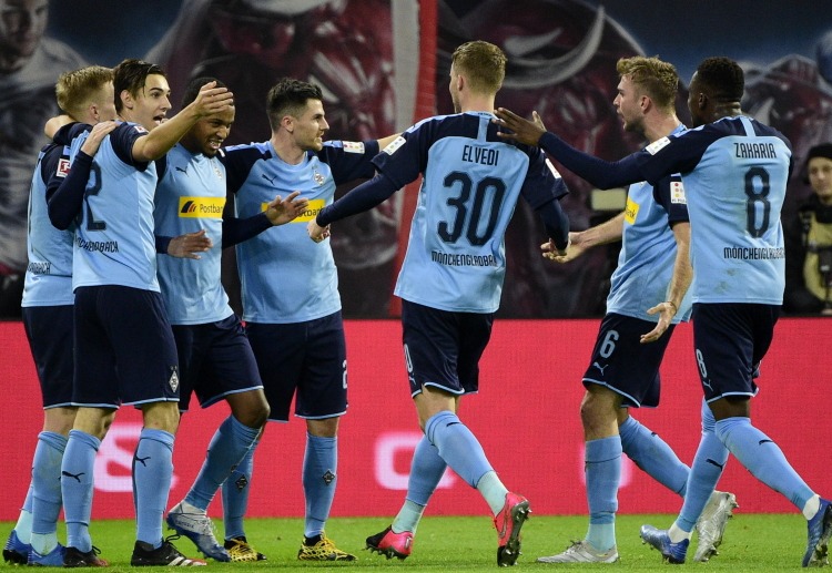 Alassane Plea celebrates with Gladbach teammates after scoring their first goal against RB Leipzig in Bundesliga