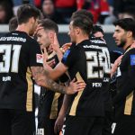 Lukas Petkov shares a celebratory moment with teammates during their Bundesliga relegation clash with FC Heidenheim